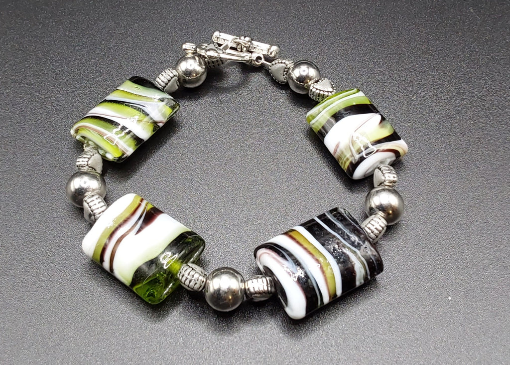 Marble Green Black White with Silver Clasp Bracelet striped beads on a black background